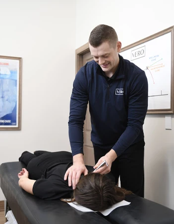 Chiropractor West Des Moines IA Logan Dabney with Patient